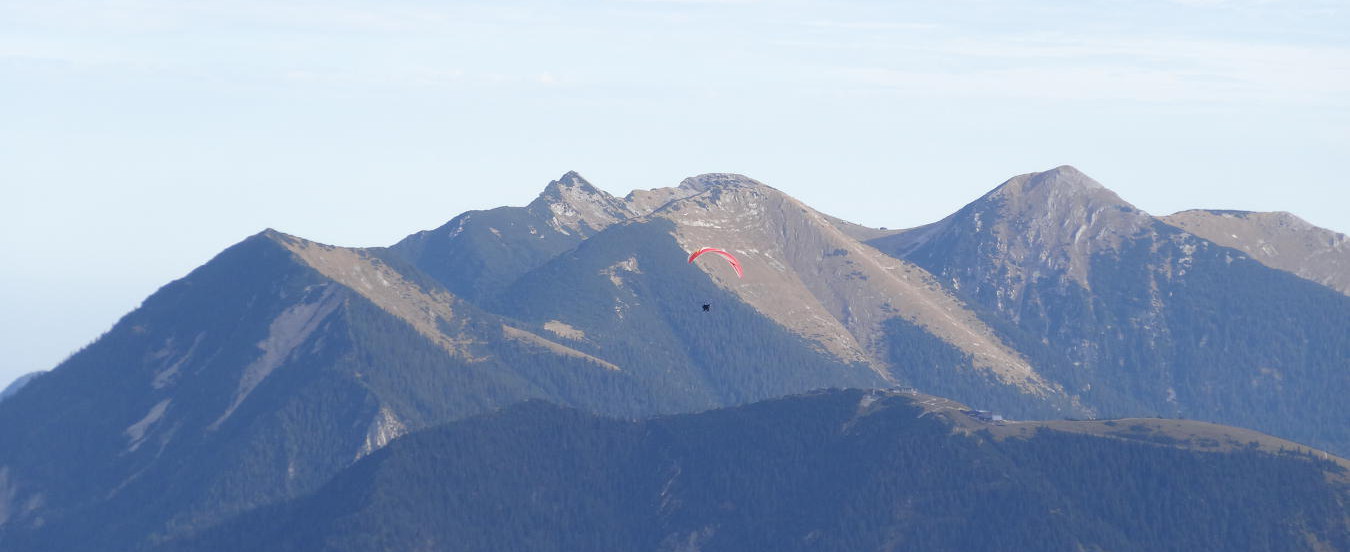 Ein Gleitschirmflieger vor dem Estergebirge.